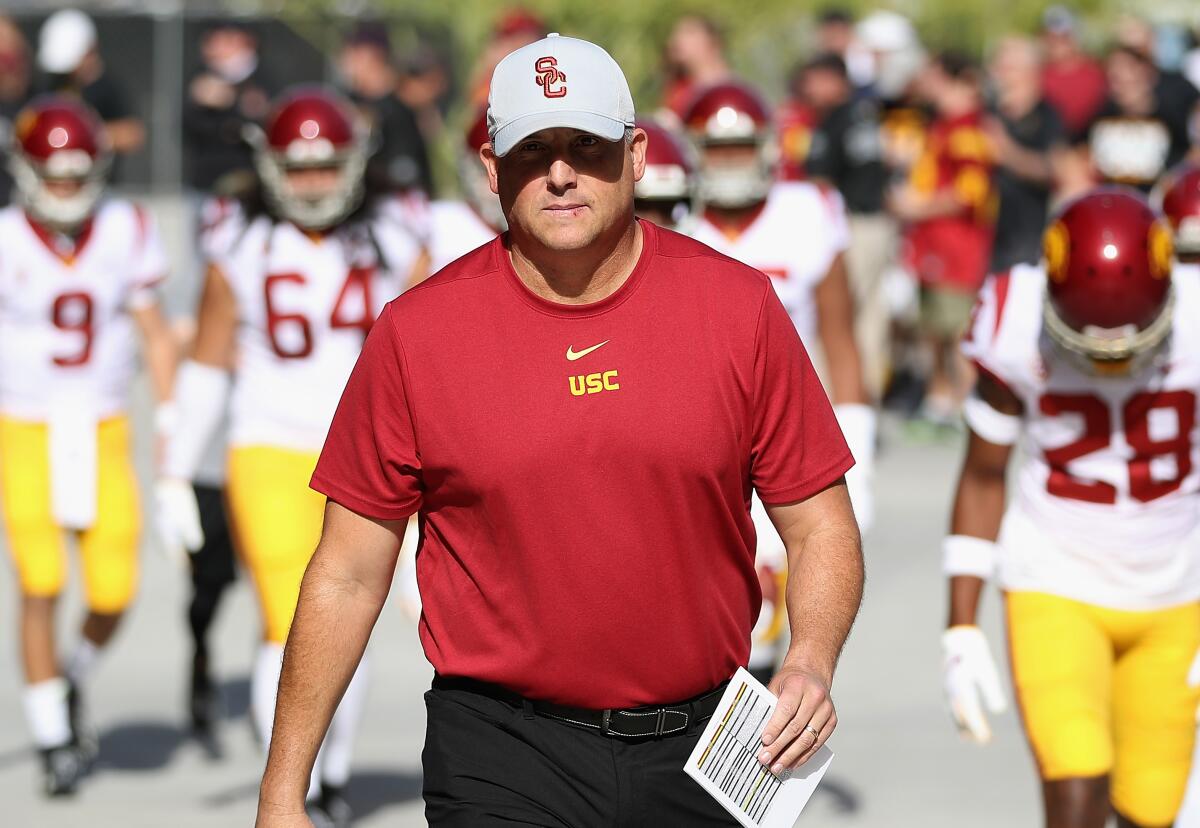 USC coach Clay Helton leads his players onto the field before a game against Arizona State on Nov. 9.