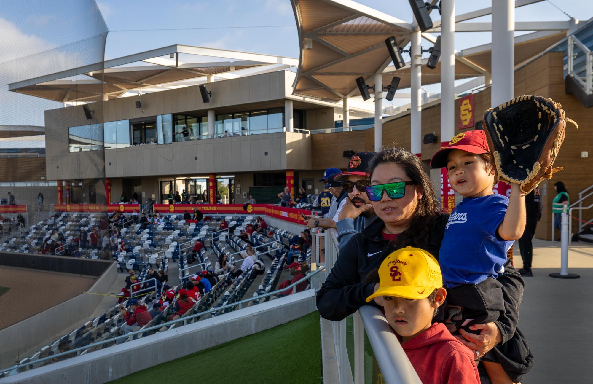 Bobby and Blaire Burkitt, and their kids Tre, 8, Nicholas, 6, watches USC warm up before the game in Irvine on May 3.