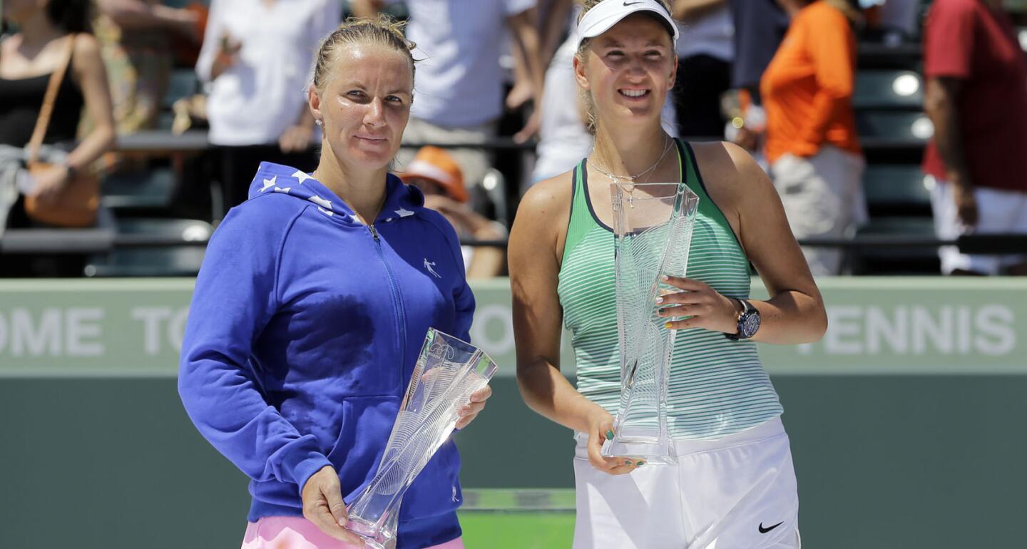 Svetlana Kuznetsova, left, of Russia, and Victoria Azarenka, of Belarus, pose with their trophy after the women's singles final at the Miami Open tennis tournament in Key Biscayne, Fla. Azarenka won 6-3, 6-2.