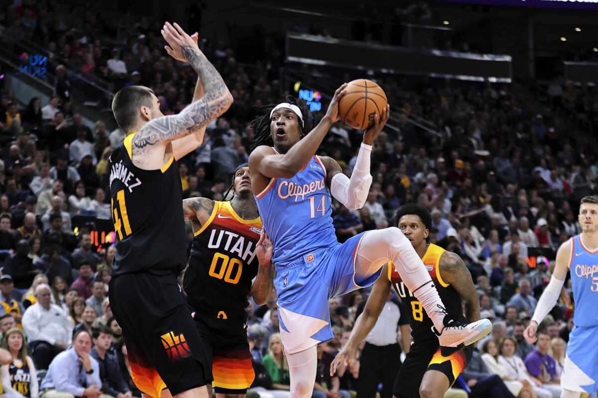 Clippers guard Terance Mann (14) goes up for a shot against Utah Jazz forward Juancho Hernangomez.