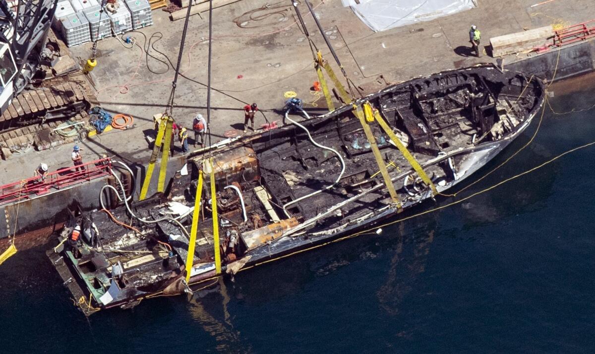 A salvage team raises the hull of the Conception off Santa Cruz Island.
