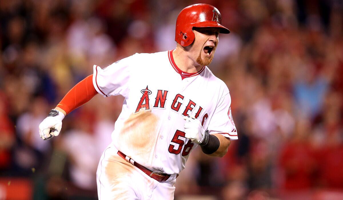 Angels' Kole Calhoun reacts as he runs to first after hitting a solo home run in the eighth inning to give the Angels the lead against the Oakland Athletics at Angel Stadium of Anaheim on Friday.
