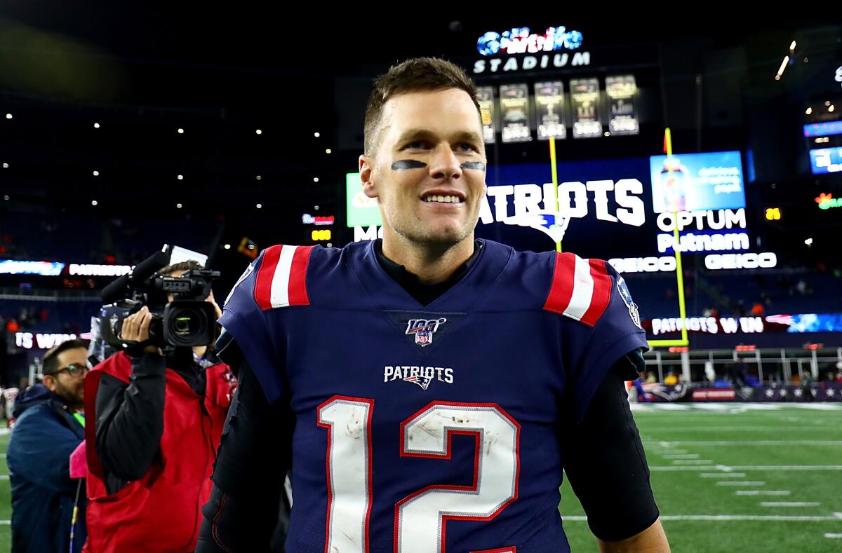 Tom Brady walks off the field.