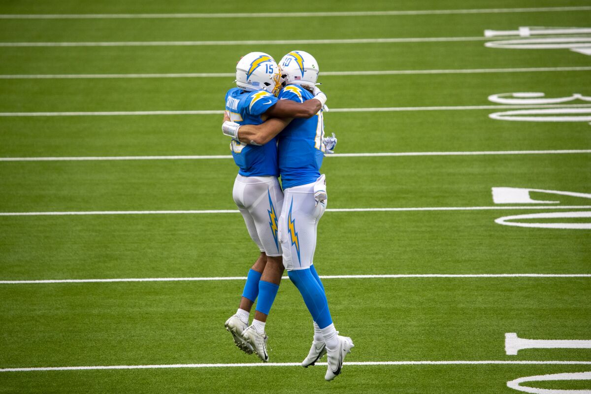 Chargers quarterback Justin Herbert, right, celebrates with wide receiver Jalen Guyton.