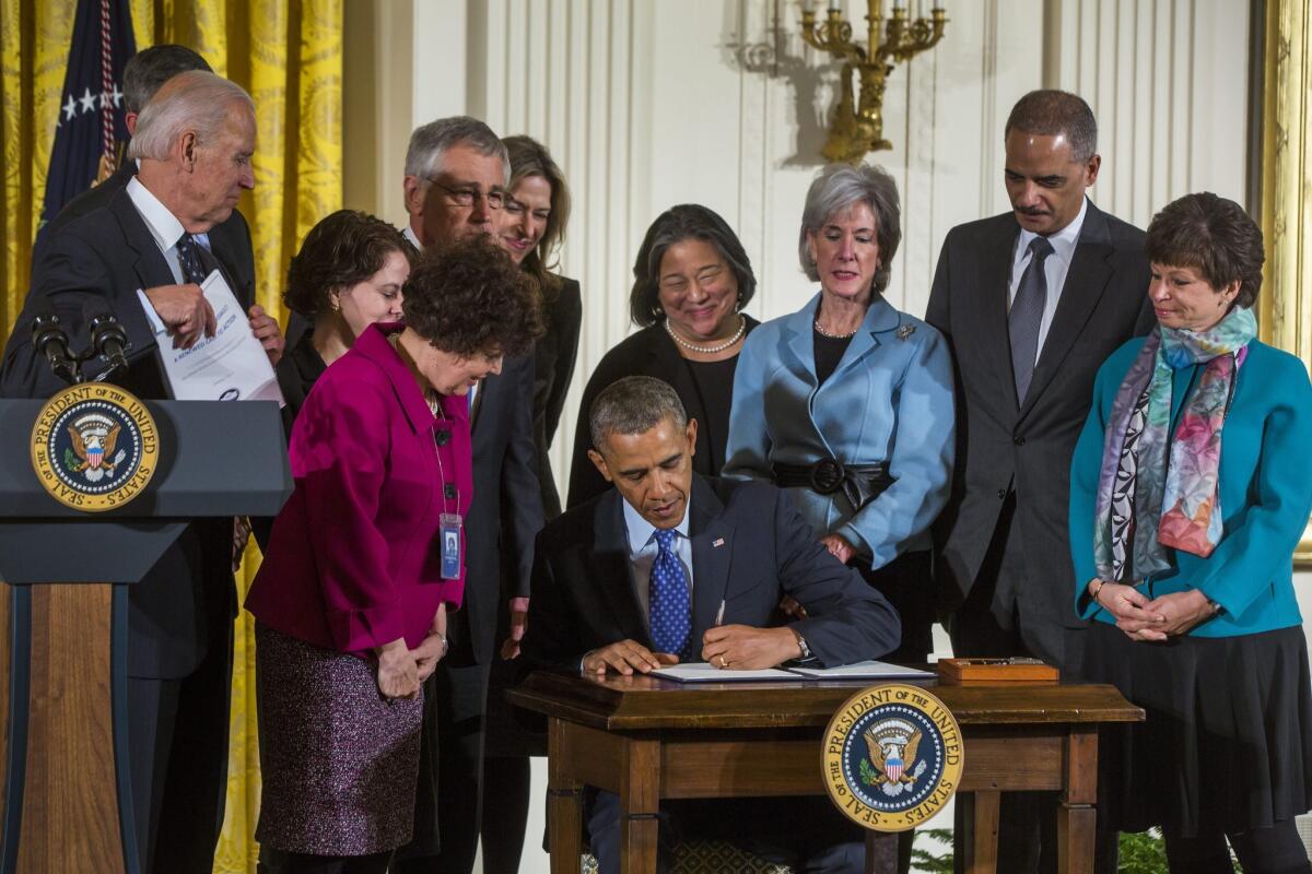 President Obama, joined by members of his cabinet, signs a presidential memorandum creating a task force to protect students from sexual assault in the East Room of the White House in Washington, DC.