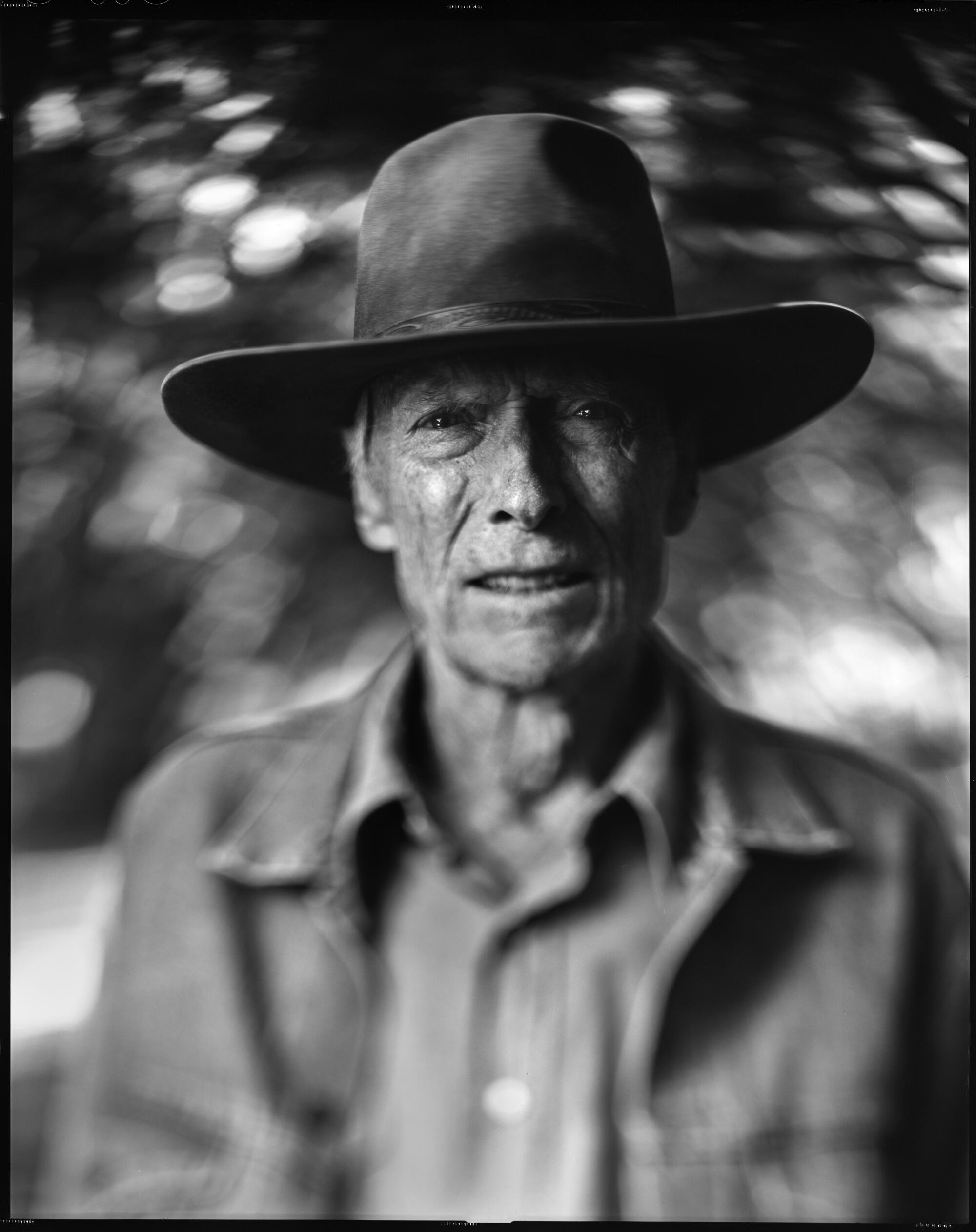 A black-and-white portrait of a man in a hat 