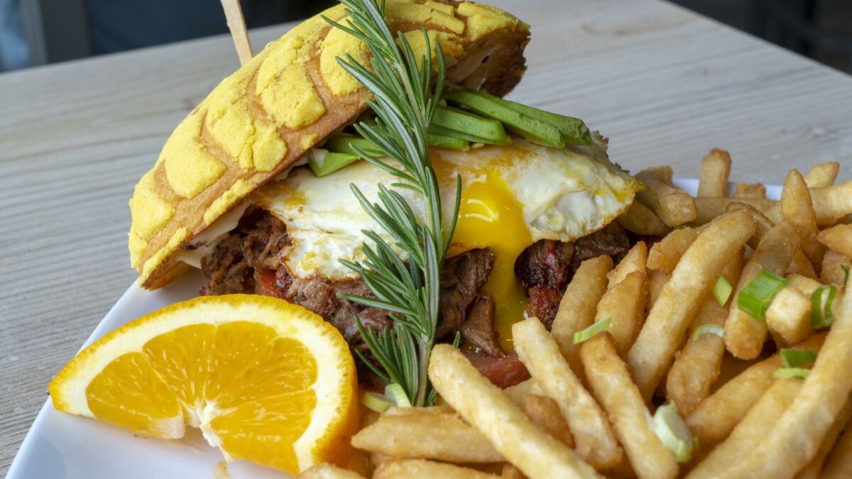 Mixing both of their Mexican and Pilipino heritages, Richard Corpus (l) and Roger Buhain offer the MexiPino Breakfast Sandwich. Served with prime smoked brisket, spam,chorizo, avocado and egg on a Mex conchita bread and a side of fries.