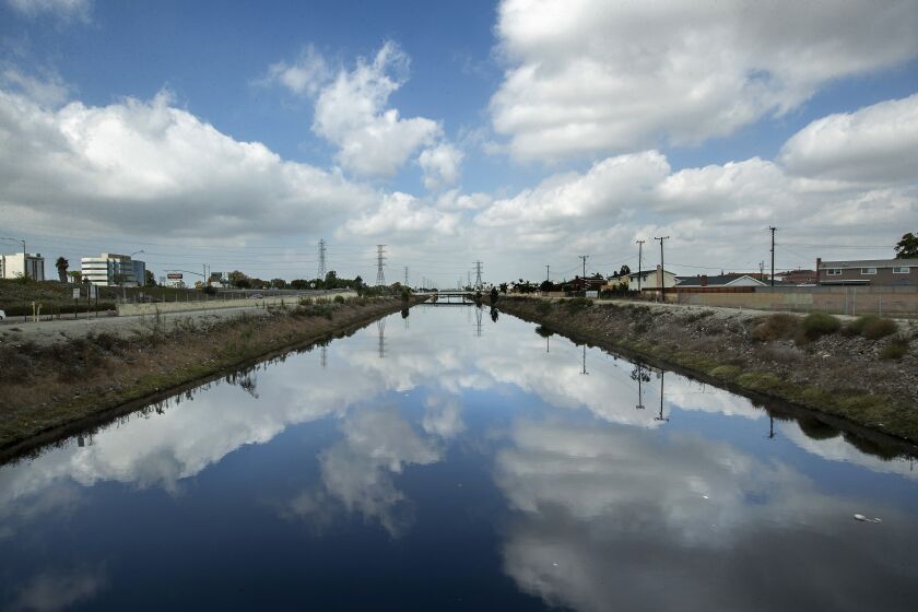 CARSON, CA - OCTOBER 11, 2021: Overall, shows the Dominguez Channel in Carson as seen from Carson St. A foul odor is emanating from the Dominguez Channel and public health officials are recommending Carson residents keep their doors and windows closed as authorities work to address the odor. The Dominguez Channel is a drain channel that crosses through industrial areas on its way to the Port of Los Angeles. (Mel Melcon / Los Angeles Times)