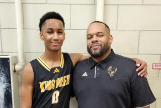 King/Drew coach Lloyd Webster with his son, Josahn, a sophomore guard who scored 18 points in win over Crenshaw.