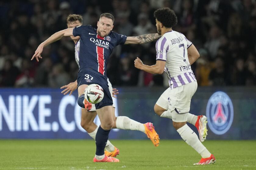 FILE - PSG's Milan Skriniar, left, is challenged by Toulouse's Zakaria Aboukhlal.