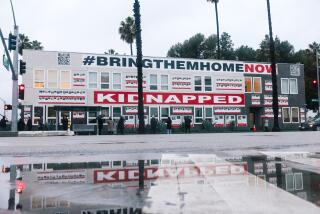 Culver City, CA - December 20: A mural titled "Bring Them Home Now," by The Combat Antisemitism Movement and Artists 4 Israel is seen on Washington Blvd on Wednesday, Dec. 20, 2023 in Culver City, CA. The mural is about 120 feet long and 22 feet high, and features images of Israeli hostages still held by Hamas, with mirrors replacing some faces to invite viewers into the captives' experience. (Dania Maxwell / Los Angeles Times)