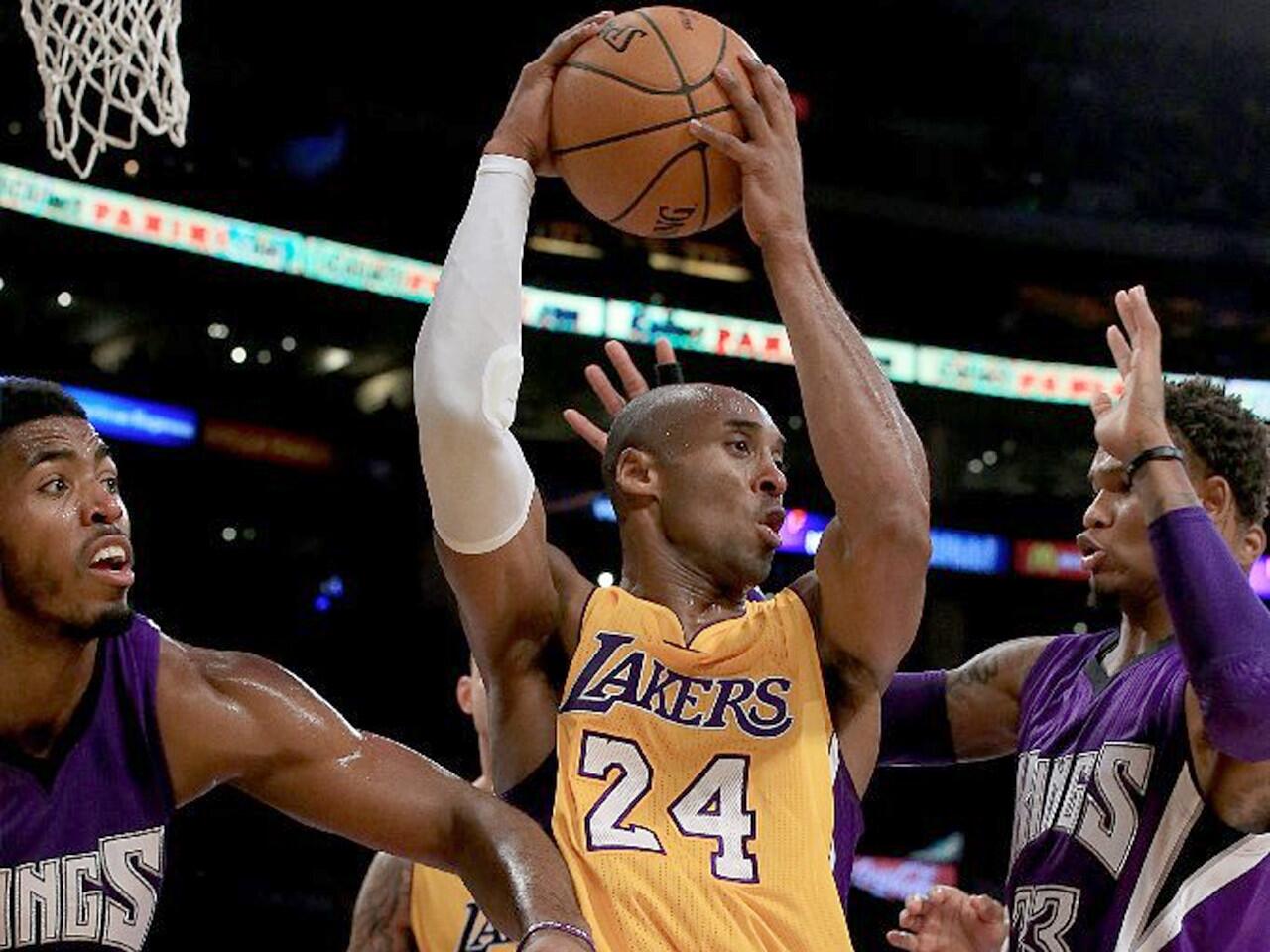 Kobe Bryant finds himself in a crowd of Kings, including Jason Thompson and forward Derrick Williams in the first quarter of the Lakers' 98-95 win over the Kings.