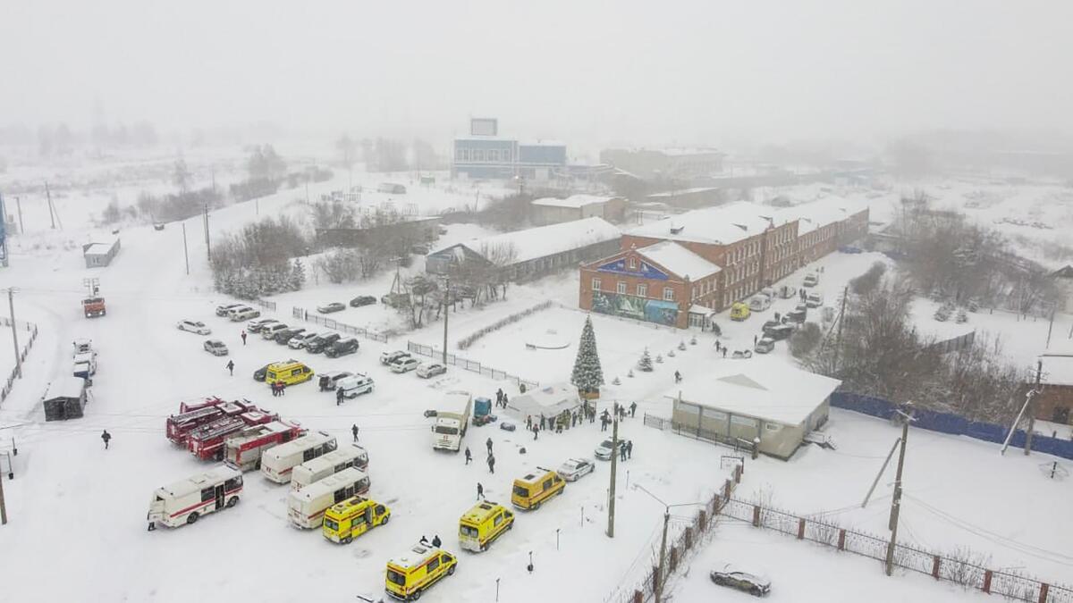 Ambulances and fire trucks are parked near the Listvyazhnaya coal mine out of the Siberian city of Kemerovo, about 3,000 kilometres (1,900 miles) east of Moscow, Russia, Thursday, Nov. 25, 2021. A fire at a coal mine in Russia's Siberia killed 11 people and injured more than 40 others on Thursday, with dozens of others still trapped, authorities said. (Governor of Kemerovo region press office photo via AP)