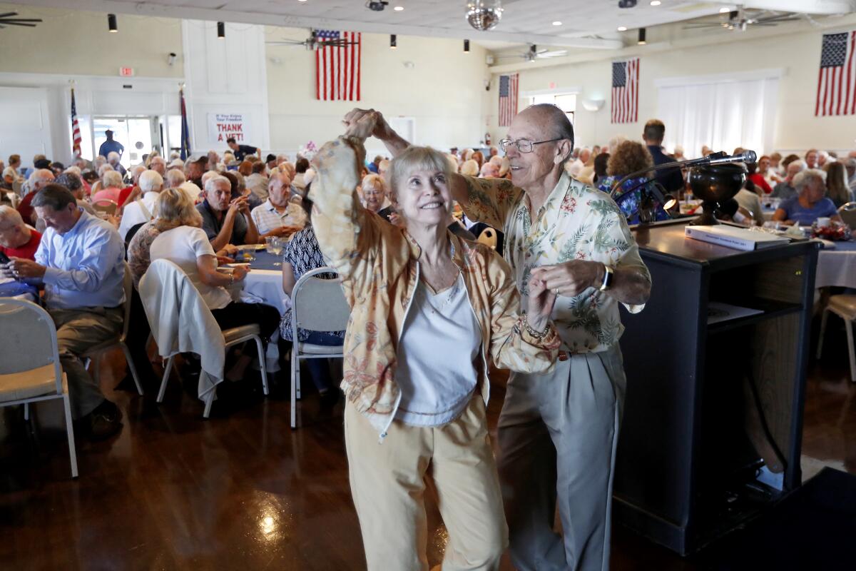 Korean War veteran Paul Rutkowski, 83, of Laguna Woods spins his wife, Barbara, 75, as they dance during a luncheon for World War II and Korean War veterans Thursday at American Legion Post 291 in Newport Beach.
