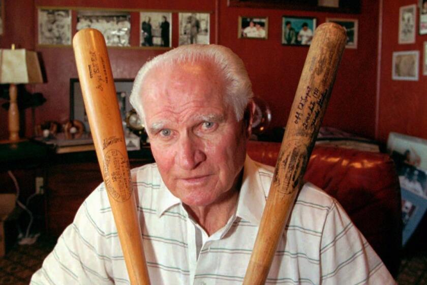 Baseball Hall of Famer Bobby Doerr sits among his collected memorbilia in his Eugene, Ore. home Wednesday, July 20, 1994.(AP Photo/Shane Young)