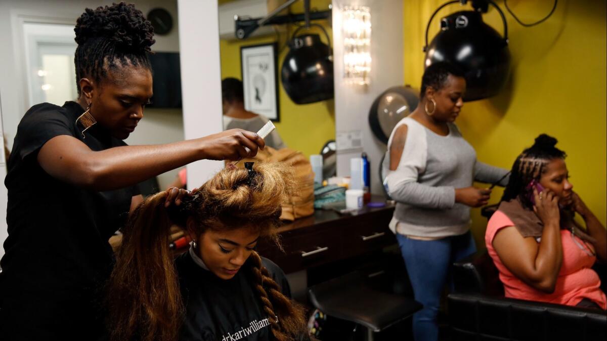 Kari Williams, left, who is an expert in hair and scalp care, said that common methods of straightening or chemically treating black hair often damage the hair and scalp.