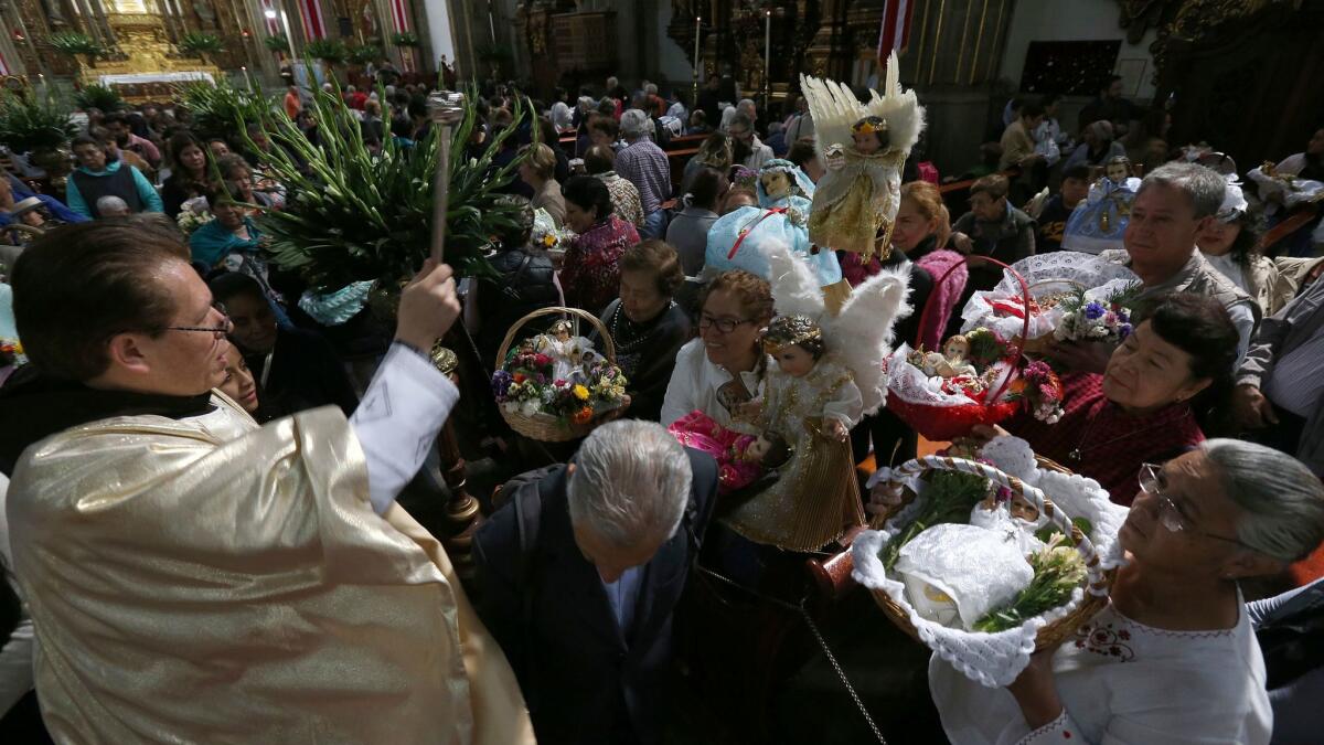 A priest celebrating the Feast of Candelaria in Mexico City on Feb. 2, 2018. Two priests from Guerrero state were killed three days later after celebrating the feast day in the small town of Juliantla.