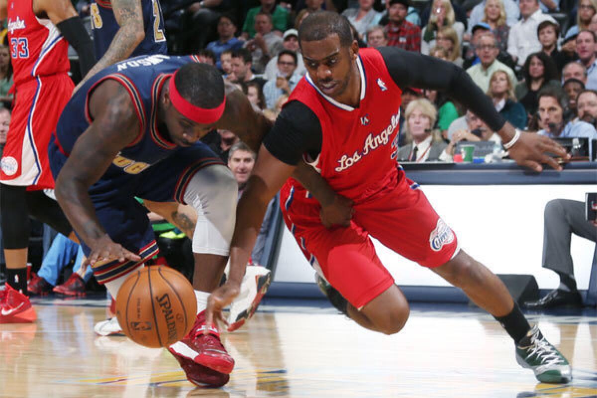 Chris Paul and Denver's Ty Lawson pursue a loose ball during a game last month.
