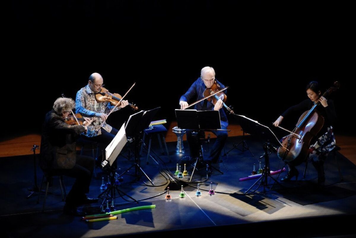 Kronos Quartet's David Harrington, left, John Sherba, Hank Dutt and Sunny Yang perform at the Musco Center for the Arts at Chapman University.
