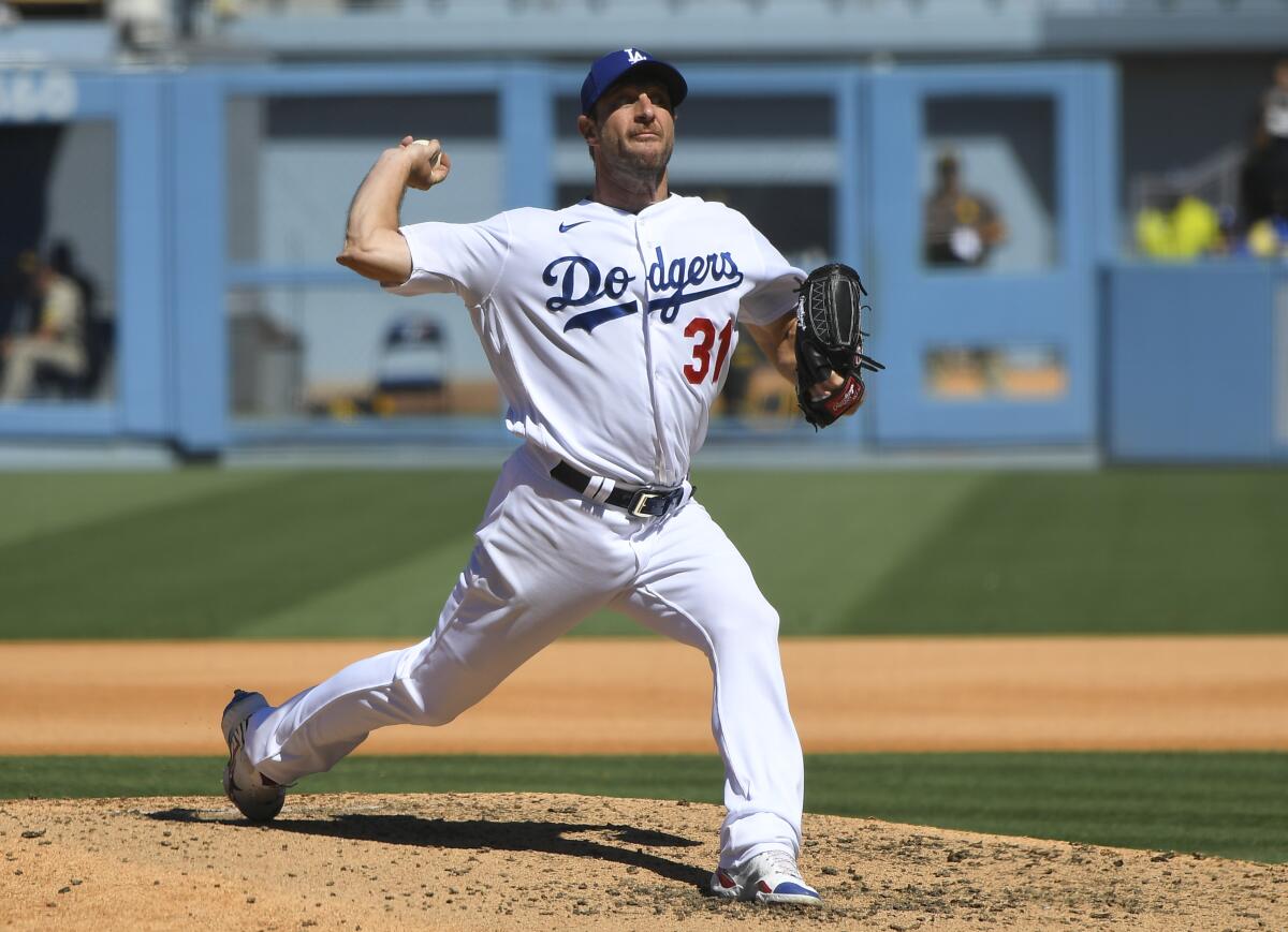 Los Angeles Dodgers Max Scherzer pitches his 3000th career strikeout with this throw against San Diego Padres first baseman Eric Hosmer in the fifth inning during in a baseball game Sunday, Sept. 12, 2021, in Los Angeles, Calif. (AP Photo/John McCoy)