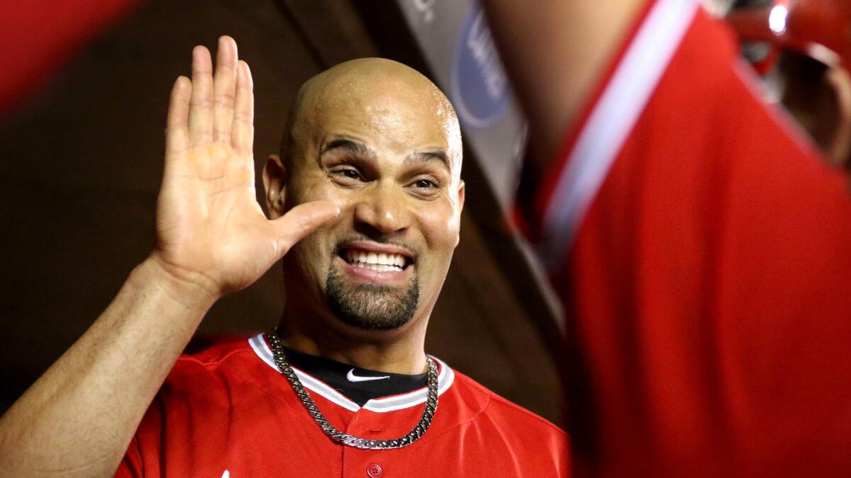 Angels designated hitter Albert Pujols greets teammate Kole Cahhoun in the seventh inning after they had each hit a home run against the Twins.