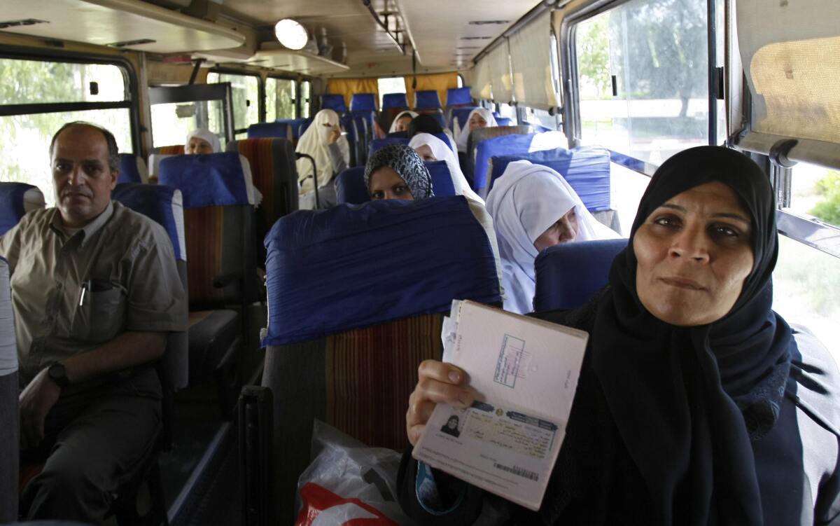 A Palestinian woman shows her visa 