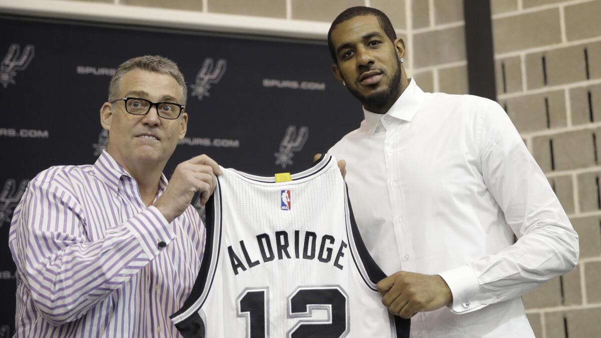 LaMarcus Aldridge, right, poses with San Antonio Spurs General Manager R.C. Buford during a news conference in San Antonio on Friday.