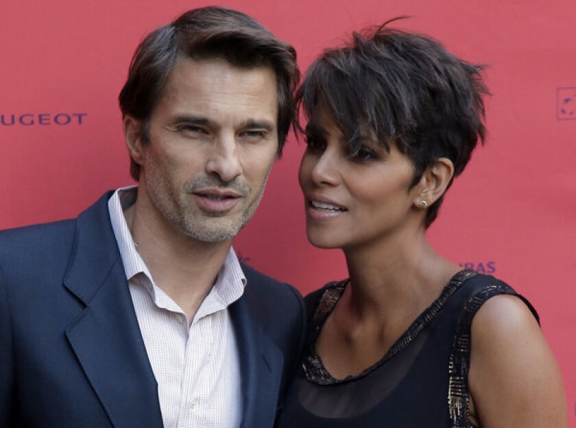 Halle Berry, right, and Olivier Martinez pose for the cameras before a screening of the film "Things We Lost in the Fire" during the Champs-Elysees Film Festival on June 13.