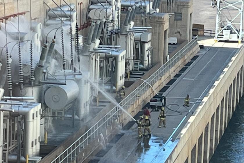 A fire crew puts out flames at the Hoover Dam.