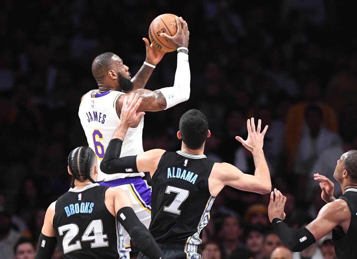 Lakers forward LeBron James beats the Grizzlies' defense down the lane to score a basket.