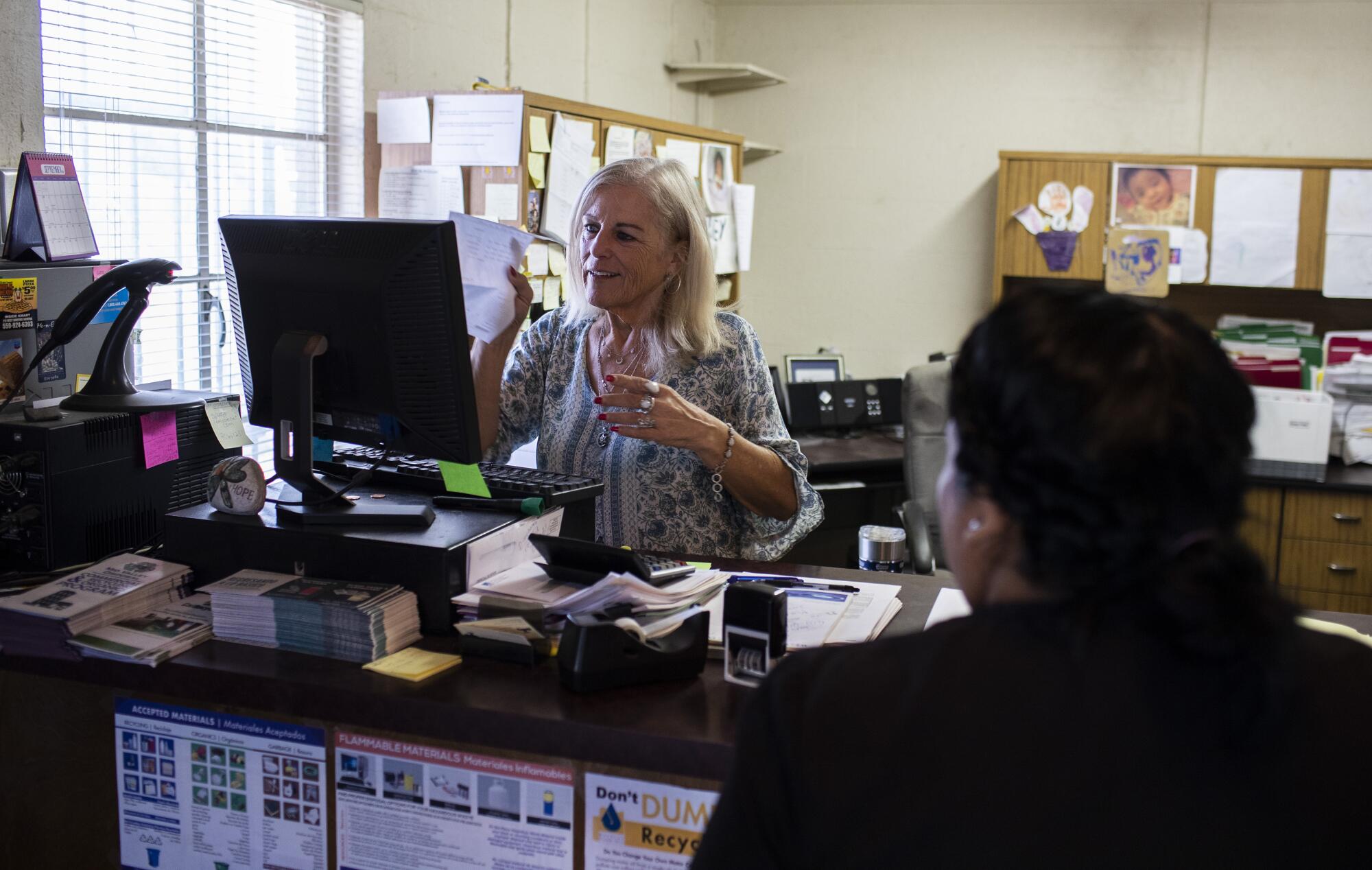 Public Utility District office manager Patty Silva processes a customer's bill.