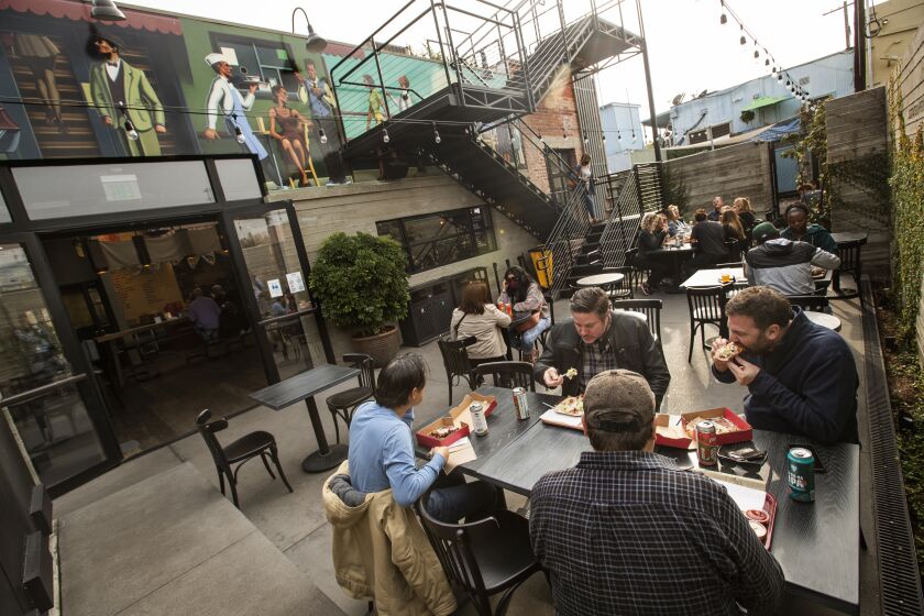 CULVER CITY, CA - November 19, 2021: Customers dine in the outside back patio at Citizen Public Market, Culver City's newest food hall. Located in a restored former publishing house, the two-story space features eight restaurants, with seating on its back patio and rooftop deck. (Mel Melcon / Los Angeles Times)