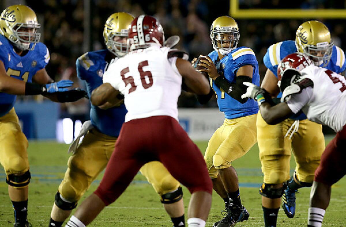 The UCLA offensive line gives quarterback Brett Hundley plenty of time in the pocket against the New Mexico State pass rush in the first quarter of a game earlier this season.