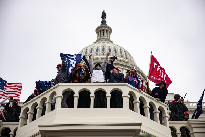 People with "Trump" flags at the U.S. Capitol.