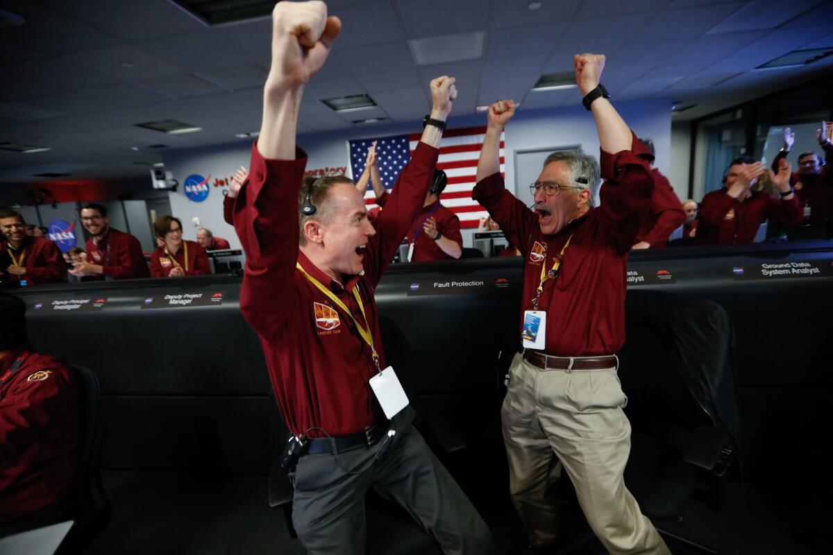 Kris Bruvold, left, and Sandy Krasner at the Jet Propulsion Laboratory in La Cañada Flintridge react after receiving confirmation that the Mars InSight lander successfully touched down on the surface of Mars.