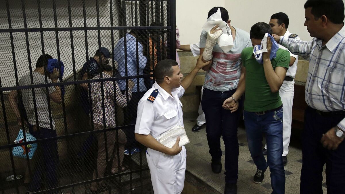 Eight Egyptian men leave the defendants' cage in a Cairo courtroom after being convicted on Nov. 1, 2014, for "inciting debauchery." Their case stemmed from their appearance in a video of an alleged same-sex wedding party on a Nile boat.