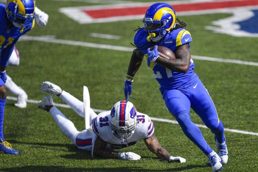 Los Angeles Rams' Darrell Henderson (27) rushes past Buffalo Bills' Dean Marlowe (31) during the first half of an NFL football game Sunday, Aug. 26, 2018, in Orchard Park, N.Y. (AP Photo/Adrian Kraus)
