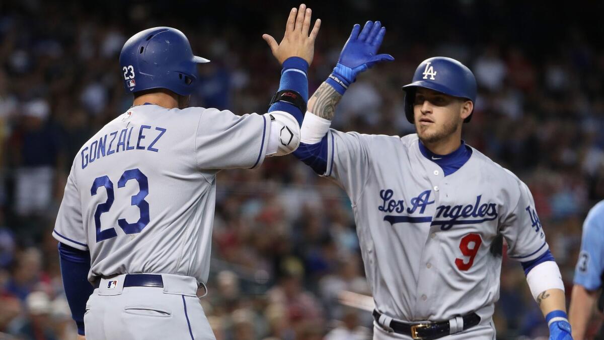 Adrian Gonzalez greets Yasmani Grandal after Grandal's two-run homer Sunday against Arizona.