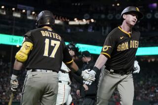 San Diego Padres' Garrett Cooper, right, is congratulated by Matthew Batten (17) after hitting a home run against the San Francisco Giants during the seventh inning of a baseball game in San Francisco, Wednesday, Sept. 27, 2023. (AP Photo/Jeff Chiu)