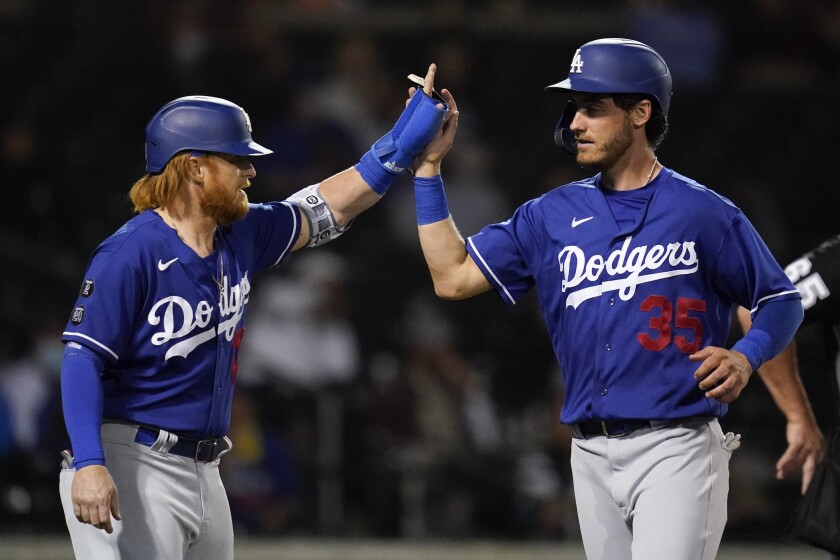 Dodgers' Justin Turner high-fives Cody Bellinger.