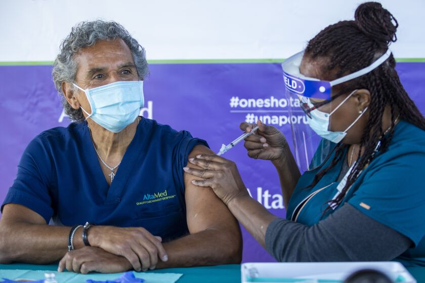 Anaheim, CA - January 28: Darlene Dickens-Jeffers, right, senior manager of infection prevention at AltaMed Health Services, gives a Moderna COVID-19 vaccination to former Los Angeles Mayor Antonio Villaraigosa, who wants to send a message to encourage other seniors to get their vaccination shots at AltaMed Health Services Medical and Dental Group in Anaheim Thursday, Jan. 28, 2021. (Allen J. Schaben / Los Angeles Times)