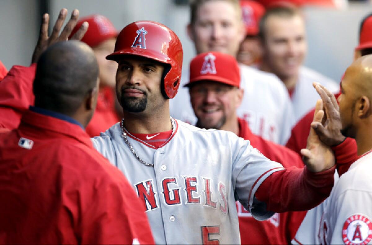 Angels first baseman Albert Pujols celebrates with teammates after scoring against the Chicago White Sox during a game last season.
