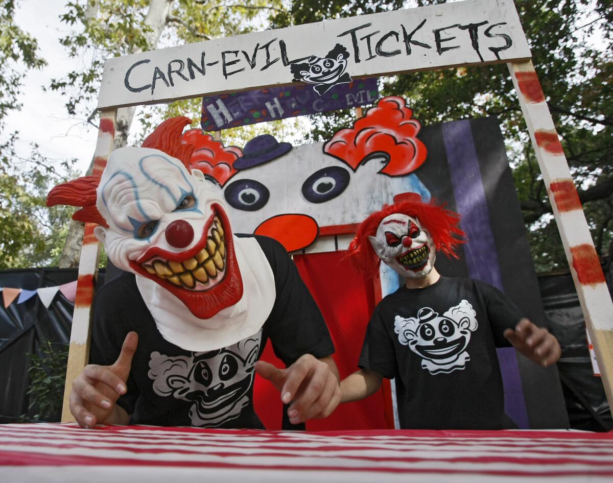 Jeremy Herron, left, and his friend Timmy Fejtek, right, are ready to get visitors to their Haunted House at 5920 Hampton in La Canada Flintridge on Saturday, Oct. 26, 2013. Herron, with the help of family and friends, has built the haunted house for the last three years.