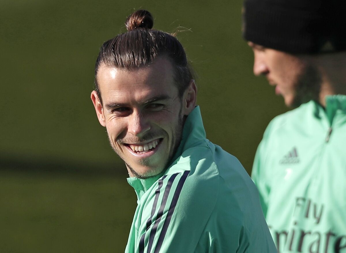 FILE - In this Monday, Nov. 25, 2019 file photo, Real Madrid's Gareth Bale takes part in a training session at the team's Valdebebas training ground in Madrid, Spain. Out of favor at Real Madrid, Gareth Bale is hoping to secure a return to Premier League club Tottenham. Bale's agent, Jonathan Barnett, confirmed to The Associated Press that he is in talks with Tottenham Hotspur. (AP Photo/Manu Fernandez, File)