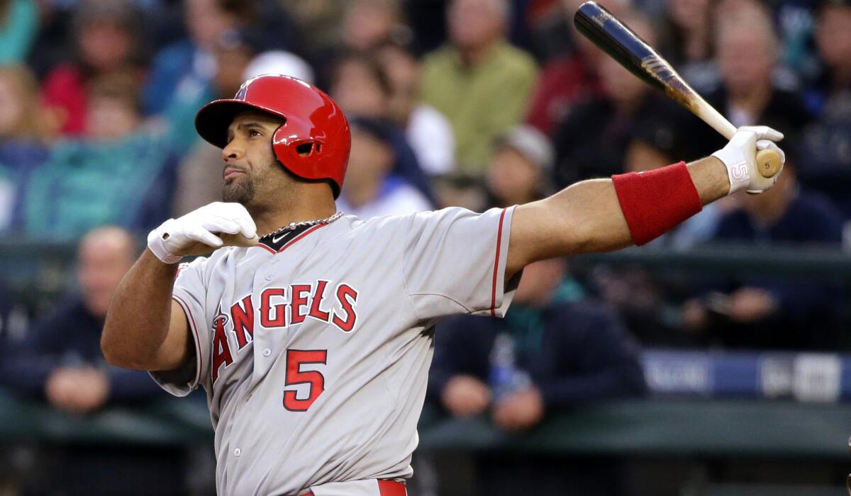Angels first baseman Albert Pujols watches his two-run home run in the first inning during a 5-3 win over the Mariners on Wednesday in Seattle.
