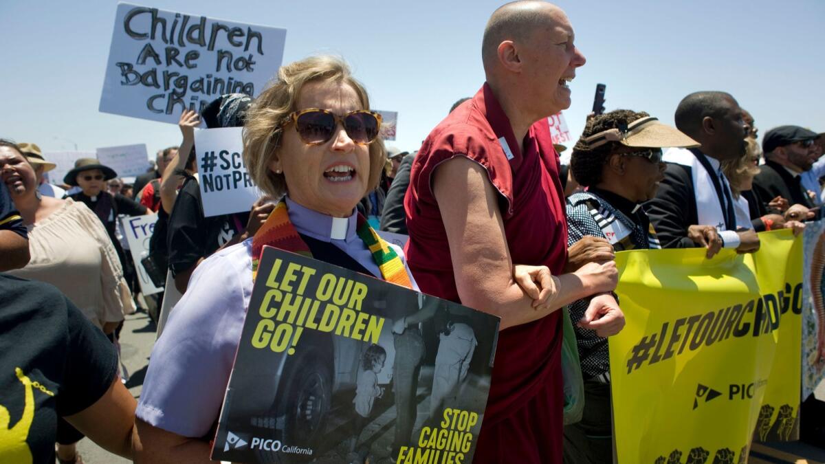 Clergy from various faiths chant outside the Otay Mesa Detention Center on Saturday at a rally for immigrant families separated at the border in San Diego.