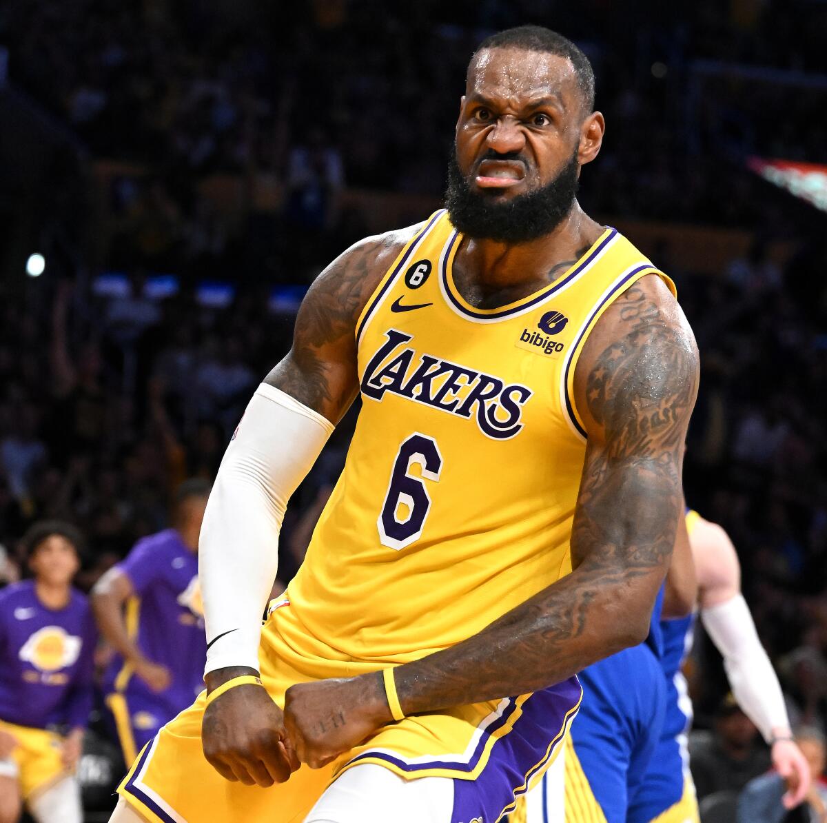 Lakers star LeBron James flexes after scoring a basket in a playoff game against the Golden State Warriors in April.