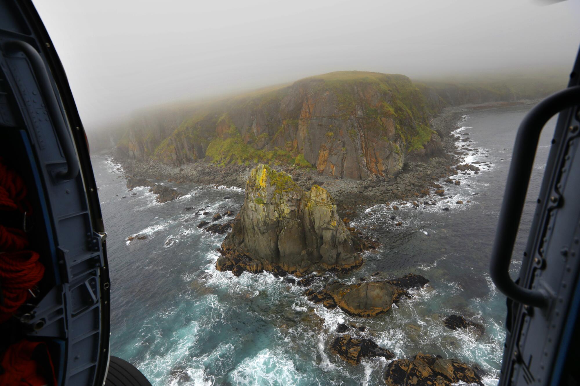 An aerial view of rugged islands in choppy seas