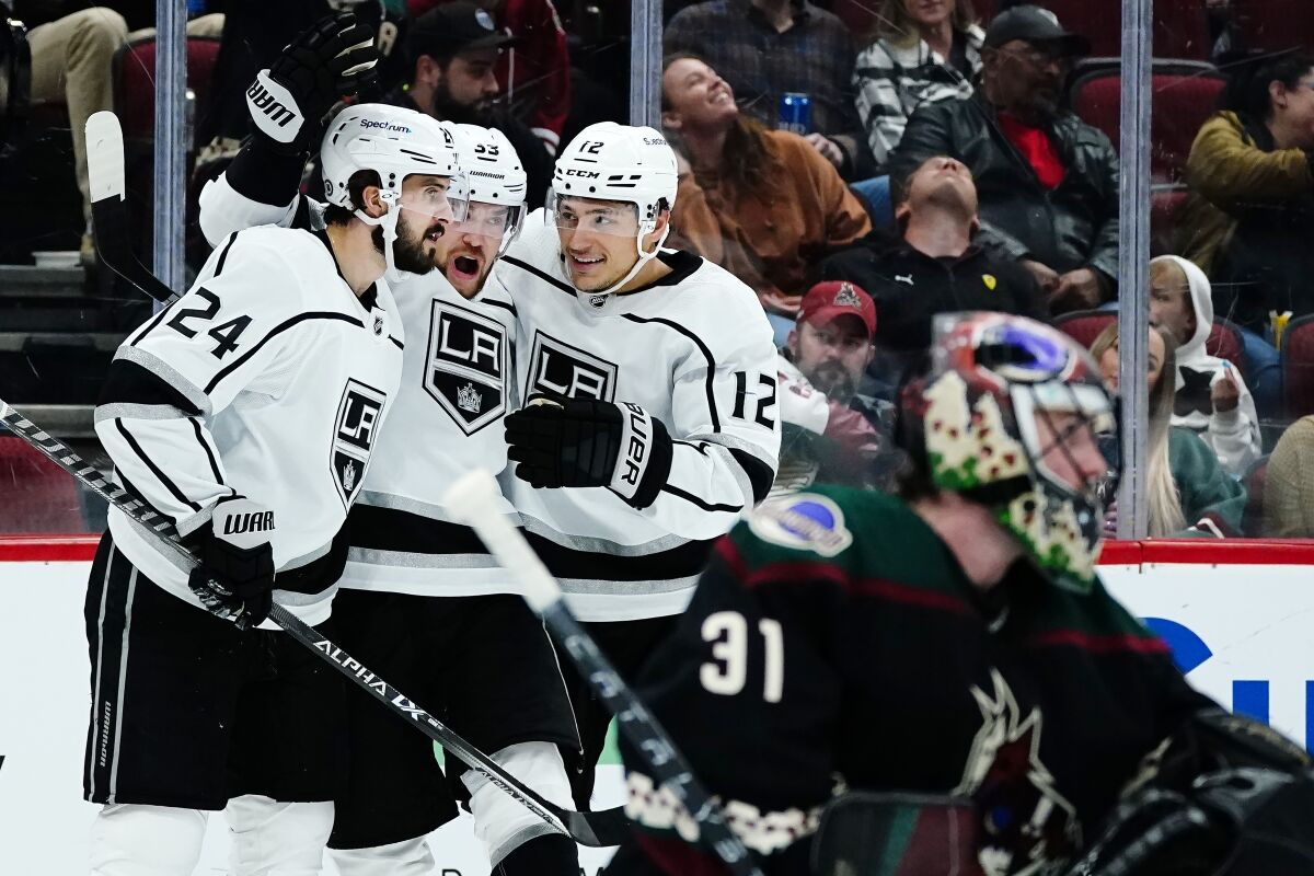 Kings left wing Viktor Arvidsson celebrates his goal with centers Phillip Danault and Trevor Moore.