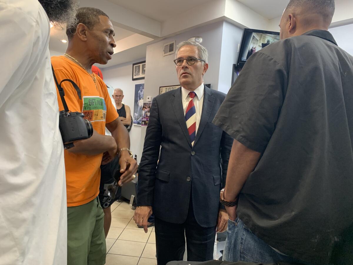 Philadelphia DA Larry Krasner engages in some politicking at a city barbershop on July 12.